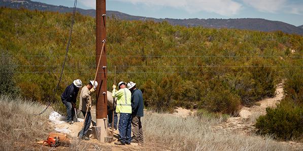 Service techs installing pole 2